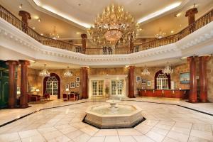 a large lobby with a chandelier and a fountain at ITC Windsor, a Luxury Collection Hotel, Bengaluru in Bengaluru +37 photos