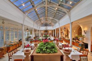 a restaurant with tables and chairs and a ceiling at ITC Windsor, a Luxury Collection Hotel, Bengaluru in Bengaluru