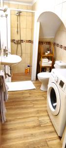 a bathroom with a washer and a toilet and a sink at Santi e Benny Apartment in Ponta Delgada