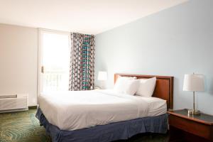 ein Hotelzimmer mit einem Bett und einem Fenster in der Unterkunft Silver Beach Hotel in Saint Joseph