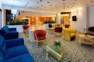 a lobby with couches and chairs in a building at Four Points by Sheraton Medellín in Medellín