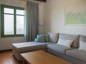 a living room with a couch and a table at Bella Resorts Andros in Andros