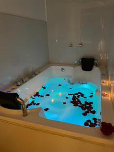 a bathroom with a bath tub with a painting on the floor at HOTEL KILLASUMAQ in Cajamarca