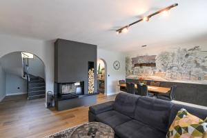 a living room with a couch and a fireplace at Villa Suzana grijani bazen i biljar na otvorenom in Veprinac