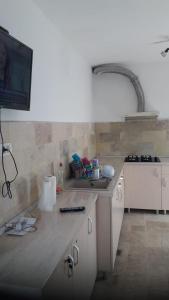 a kitchen with a sink and a counter top at CASA DRAGOȘ in Saturn