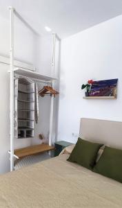 a bedroom with a bed and a book shelf at Estudio Patio San Paulino in Barbate