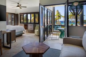 a hotel room with a king bed and a view of the ocean at Carambola Beach Resort St. Croix, US Virgin Islands in North Star