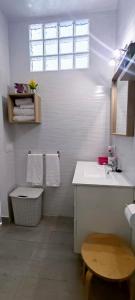 a white bathroom with a sink and a toilet at Estudio Patio San Paulino in Barbate