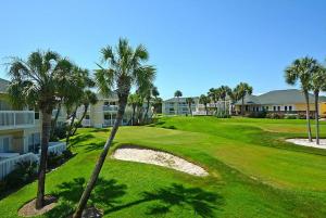 a view of a golf course with palm trees at Sandpiper Cove 8224 in Destin