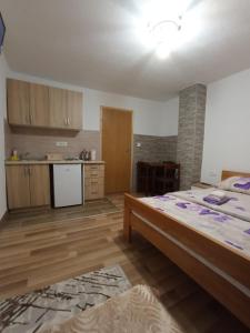 a kitchen with a large bed in a room at Apartments Nemanja in Žabljak