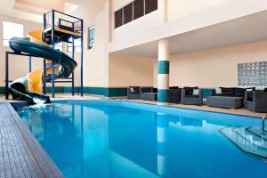 a swimming pool with a slide in a hotel at Four Points by Sheraton Hotel & Suites Calgary West in Calgary