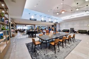 a dining room with a table and chairs at Sheraton Laval Hotel in Laval