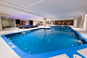 a large swimming pool in a hotel room at Sheraton Laval Hotel in Laval