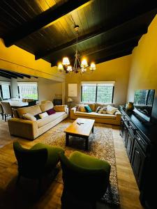 a living room with couches and a table at Casa en Bariloche Familiar - R2046 in San Carlos de Bariloche
