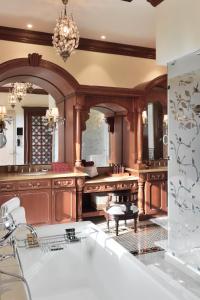 a large kitchen with wooden cabinets and a chandelier at ITC Grand Bharat, a Luxury Collection Retreat, Gurgaon, New Delhi Capital Region in Gurgaon