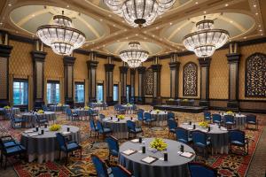 a banquet hall with tables and chairs and chandeliers at ITC Grand Bharat, a Luxury Collection Retreat, Gurgaon, New Delhi Capital Region in Gurgaon