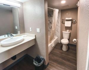 a bathroom with a sink and a toilet and a tub at Motel 6-West Sacramento, CA in West Sacramento +15 photos