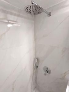 a bathroom with a shower with a shower head at Beautiful 1 bedroom flat near Olympic Stadium in Athens