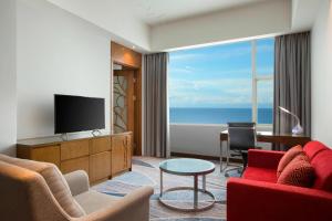 a hotel room with a room with a view of the ocean at Four Points by Sheraton Manado in Manado