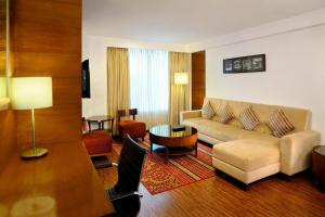 a living room with a couch and a table at Four Points by Sheraton Ahmedabad in Ahmedabad
