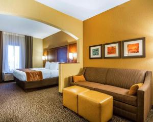 a hotel room with a bed and a couch at Comfort Suites in Ramsey