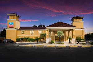 a hotel with a parking lot in front of it at SureStay Plus Hotel by Best Western San Antonio North in San Antonio