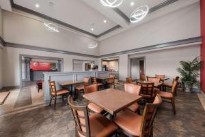 a restaurant with tables and chairs and a bar at SureStay Plus Hotel by Best Western San Antonio North in San Antonio