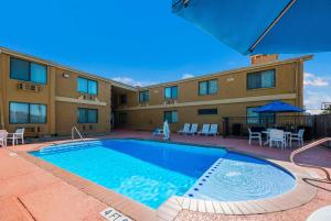 a large swimming pool in front of a building at SureStay Plus Hotel by Best Western San Antonio North in San Antonio