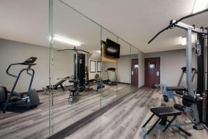 a gym with several treadmills and mirrors in a room at SureStay Plus Hotel by Best Western San Antonio North in San Antonio