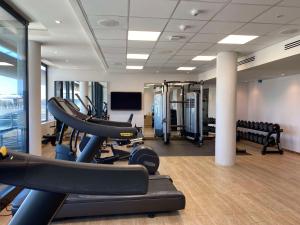 a gym with cardio equipment in a building at Radisson Hotel & Convention Centre Johannesburg, O.R. Tambo in Johannesburg