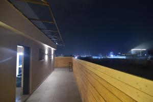 a building with a view of the city at night at מלון הברון in Ramat Eliyyahu