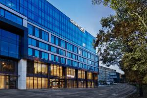 an office building with a sign on the side of it at Courtyard by Marriott Szczecin City in Szczecin