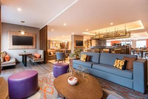 a living room with a blue couch and a table at Residence Inn by Marriott Bogota in Bogotá