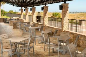 a row of tables and chairs on a patio at Four Points by Sheraton Jacksonville Beachfront in Jacksonville Beach