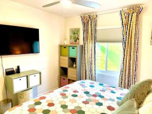 A television and/or entertainment centre at The Flamingo Palms private 1bd 1ba Unit in Duplex