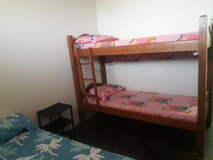 a bedroom with two bunk beds in a room at AP DA FABY in Barra de São Miguel