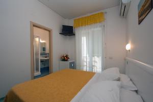 Postel nebo postele na pokoji v ubytování Hotel De Rosa
