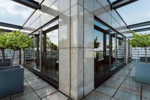 an exterior view of a building with windows and potted trees at Sheraton Berlin Grand Hotel Esplanade in Berlin