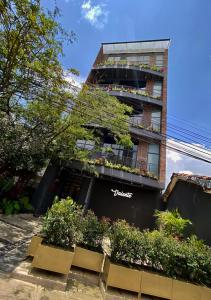 a building with a lot of plants in front of it at Royal Living in Medellín