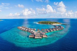 an island in the ocean with a resort at The St. Regis Maldives Vommuli Resort in Dhaalu Atoll