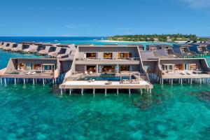 an aerial view of a resort in the water at The St. Regis Maldives Vommuli Resort in Dhaalu Atoll