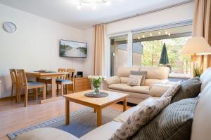 a living room with a couch and a table at AKH-044-Wellness-in-Haffkrug in Haffkrug