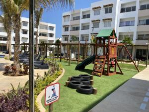 a playground at a resort with a slide at Nuevo y Muy Bonito Departamento Con Vista a la Alberca - Residencial Almarena I in Mazatlán