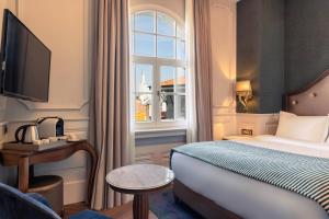 a hotel room with a bed and a window at Orientbank Hotel Istanbul, Autograph Collection in Istanbul