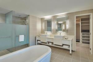 a bathroom with two sinks and a bath tub at The Westin Langkawi Resort & Spa in Kuah