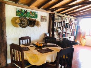 a dining room with a table and chairs and bookshelves at La Casona Llanera in San Martín