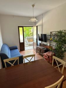 a living room with a table and a blue couch at Apartments with a parking space Mali Losinj (Losinj) - 15858 in Mali Lošinj