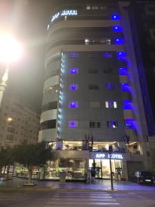 a lit up building with the eiffel tower in the background at Tanger App Hotel in Tangier