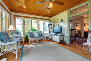 a living room with a ceiling fan and a tv at Terre Haute Manor Farmhouse with Gardens and Deck! in Midlothian