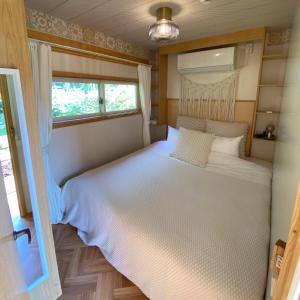 a bedroom with a large white bed with a window at R Garden in Yamanakako